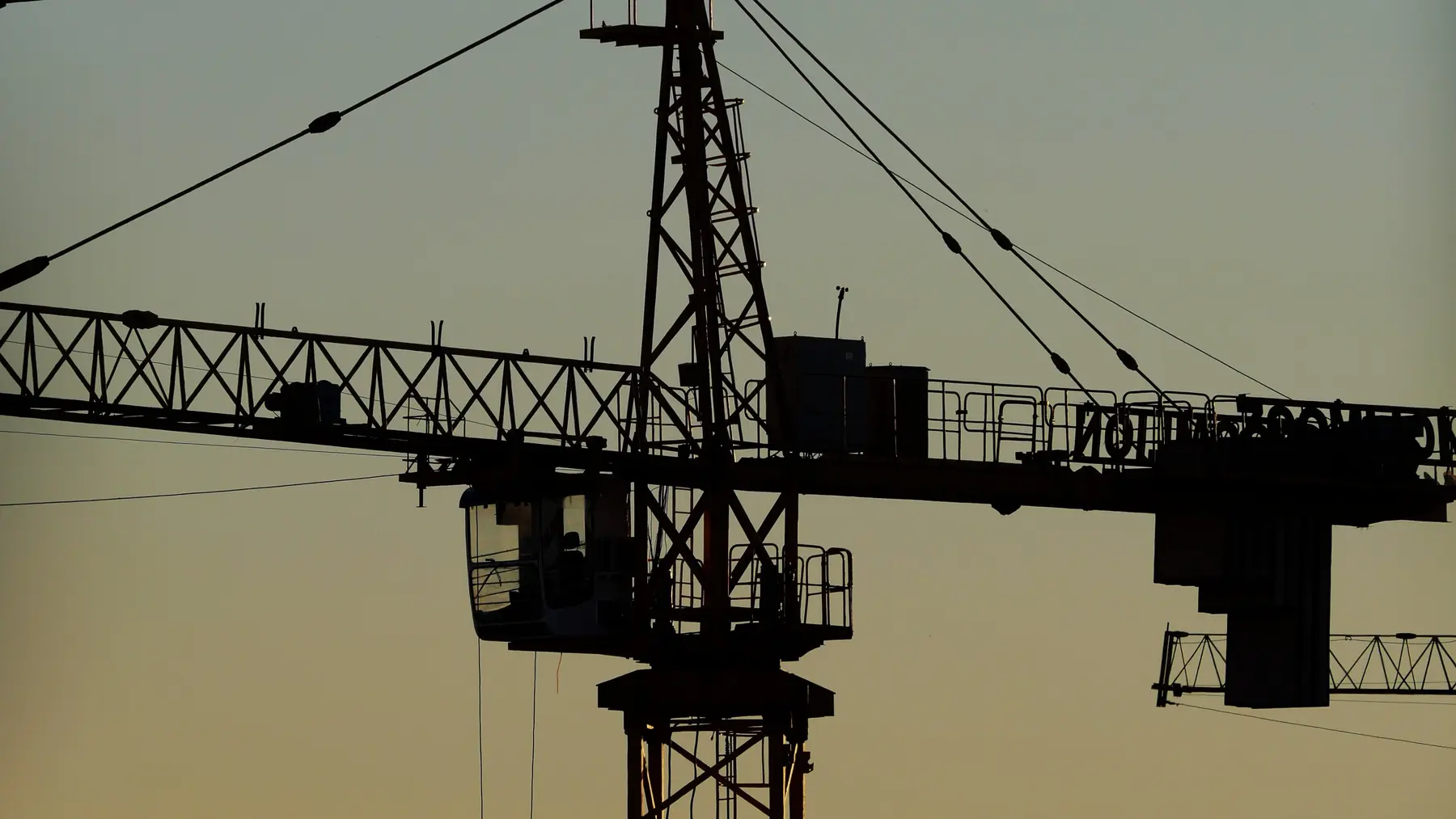 Construction cranes at dusk
